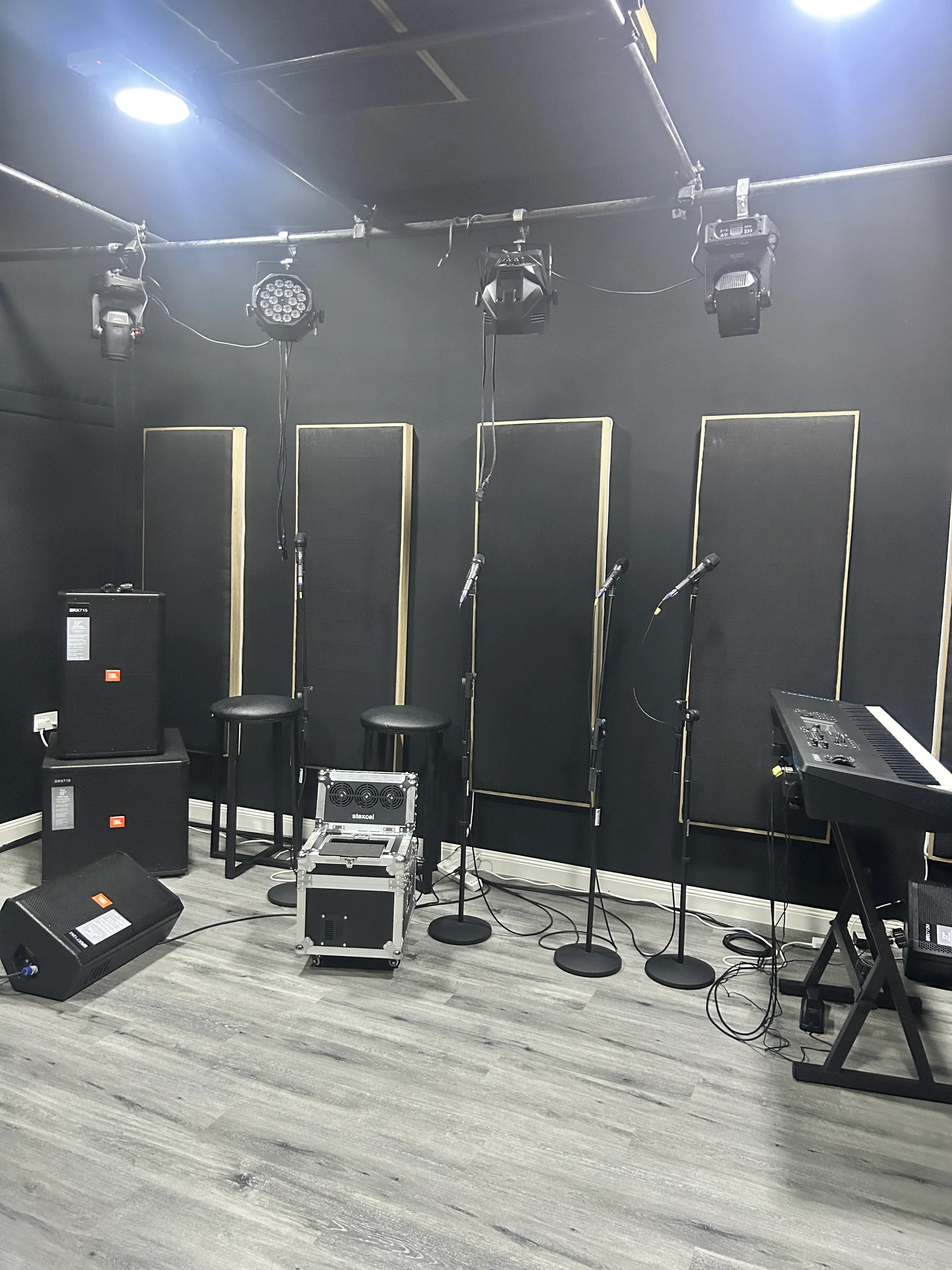 ROJ music studio with microphones, a keyboard and acoustic panels
